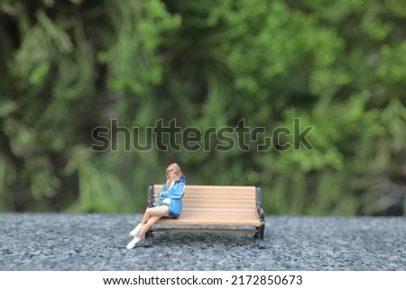 Thoughtful Woman Sitting On Bench At Park