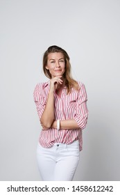 Thoughtful woman in striped shirt, portrait