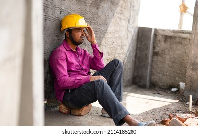 Thoughtful Worried Construction Labour At Sitting At Site - Concept Of Job Loss, Debtedness And Lonely.