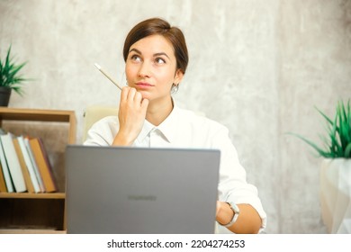 A Thoughtful, Worried European Student Worker Who Feels Insecure, Bored, Doubtful About Solving A Problem At Work With A Laptop, A Puzzled Businesswoman Looking Away, Thinking That She Has No Idea