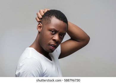 Thoughtful Young African American Man. Solving Problems, Worrying, Anxiety. Portrait On Grey Background With Free Space For Text.