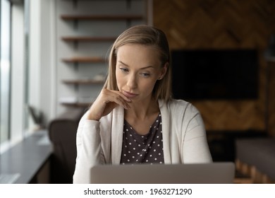 Thoughtful Young Businesswoman Look At Laptop Screen Ponder Of Business Problem Solution. Pensive Female Employee Work On Computer In Office Think Make Decision Or Plan. Dilemma Concept.