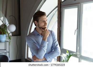 Thoughtful Young Caucasian Man Look In Window Distance Thinking Making Decision Or Plan, Contemplating, Pensive Male Lost In Thoughts, Pondering Over Problem Solution, Dilemma Concept