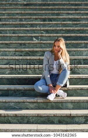 Similar – Blonde young caucasian woman smiling on steps