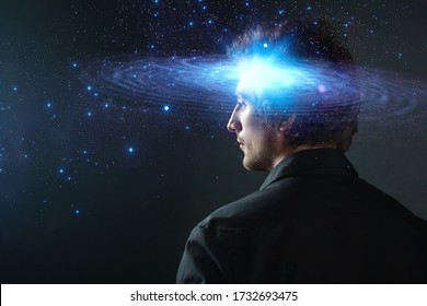 Thoughtful young man, creative mind concept. A man with a galaxy in his head, complex human consciousness and psychology, inner space