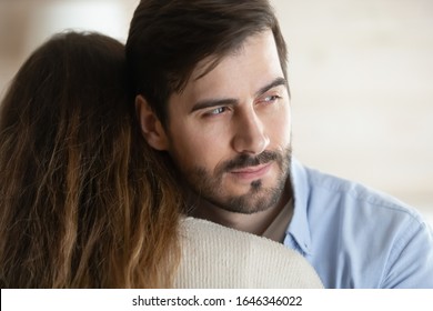 Thoughtful Young Man Hug Girlfriend Or Wife Look In Distance Thinking Pondering About Relationship Problems, Millennial Male Liar Or Cheater Make Peace With Beloved Woman, Fake Forgiveness