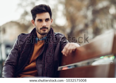 Similar – Thoughtful young man sitting on an urban bench