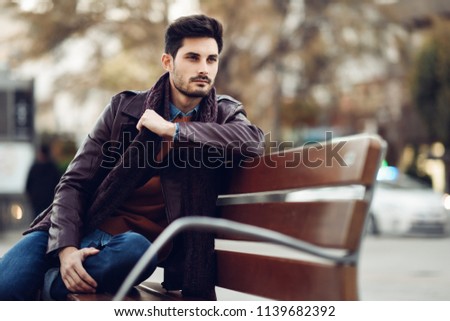 Similar – Thoughtful young man sitting on an urban bench