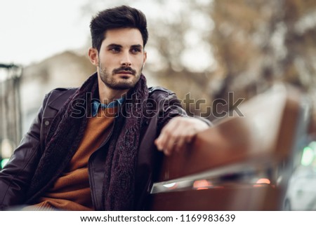 Similar – Thoughtful young man sitting on an urban bench