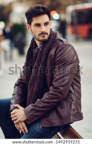 Similar – Thoughtful young man sitting on an urban bench