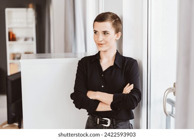 Thoughtful Young Woman Contemplating Future Endeavors in Office Space - Powered by Shutterstock