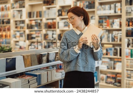 A thoughtful young woman in glasses selecting a book in a well-stocked library.