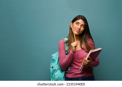 Thoughtful Young Woman. Hispanic Student In Her 20s Thinking About New Ideas To Write An Essay For Homework 