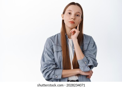 Thoughtful Young Woman With Long Hair Making Decision, Looking Serious While Thinking, Consider Options, Choosing Something And Pondering, Standing Over White Background