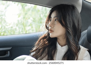 Thoughtful Young Woman Posing in Car Interior with Sunlit Background – Natural Beauty and Calm Serenity. - Powered by Shutterstock