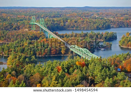 Thousand Islands Bridge across St. Lawrence River in fall in Thousand Islands National Park. This bridge connects New York State in USA and Ontario in Canada near Thousand Islands.