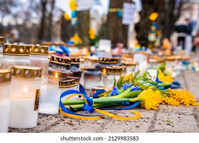 Thousands candles and flowers standing on the street during the war in Ukraine symbolising to stop the war. Stand with Ukraine sign. - Shutterstock ID 2129983583