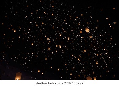 Thousands of sky lanterns released during Yi Peng Festival in Chiang Mai, Thailand.