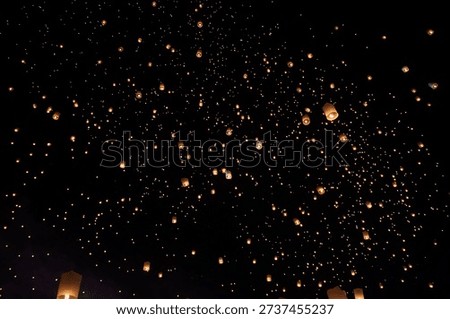 Thousands of sky lanterns released during Yi Peng Festival in Chiang Mai, Thailand.