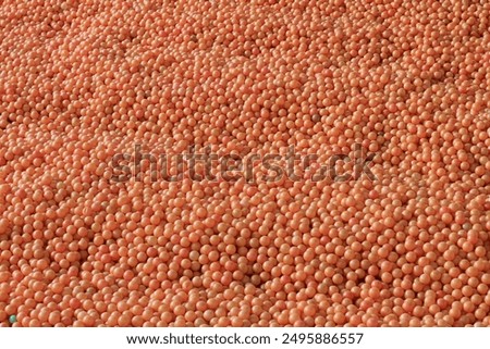 Thousands of small orange balls creating a vibrant, textured abstract background