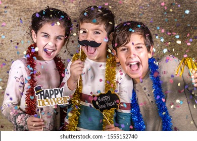 Thre Happy Kids Celebrating New Year Eve At Home