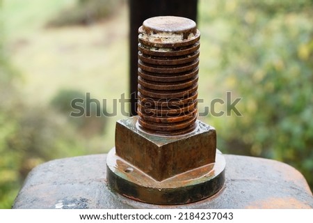 The thread of a large, rusty bolt
