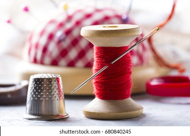 Thread needle button