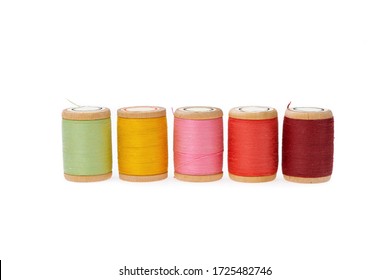 Thread  on a wooden spool. Isolated bobbins. White background. Close up