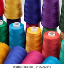 Thread spools background. Various colors sewing kit. Collection of threads. Vibrant vivid colors. Sew threads. Colorful hobby background. Tailor shop texture.