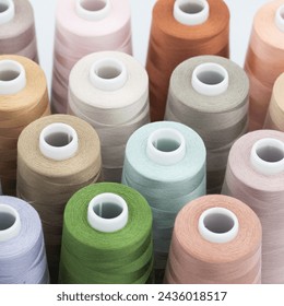 Thread spools background. Various colors sewing kit. Collection of threads. Pastel colors. Sew threads. Colorful hobby background. Tailor shop texture.