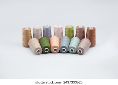 Thread spools background. Various colors sewing kit. Collection of threads. Pale pastel colors. Sew threads. Colorful hobby background. Tailor shop texture. Isolated on white.