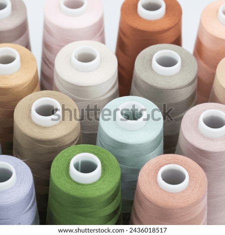 Thread spools background. Various colors sewing kit. Collection of threads. Pastel colors. Sew threads. Colorful hobby background. Tailor shop texture.
