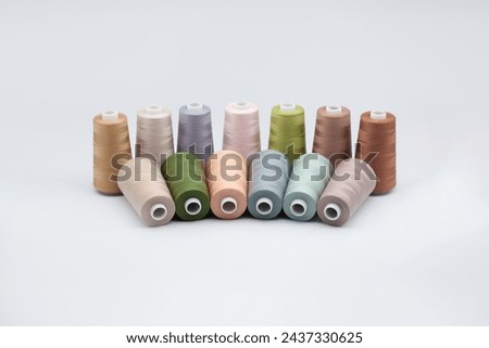 Thread spools background. Various colors sewing kit. Collection of threads. Pale pastel colors. Sew threads. Colorful hobby background. Tailor shop texture. Isolated on white.