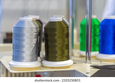 Thread Yarn Spools at Sewing Machine in Garment Factory