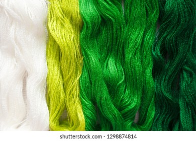 Threads of green shades on the white canvas. - Shutterstock ID 1298874814