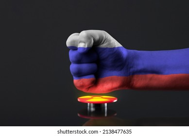 The threat of nuclear war. Russia threatens the world with nuclear weapons. A fist painted in the colors of the Russian flag presses a large red button with the symbol of a nuclear weapon.