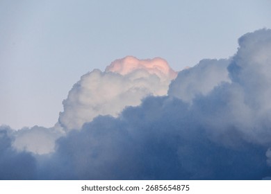 Threatening dark storm clouds with a bright pink tip over the church of St Albert in Augsburg Haunstetten