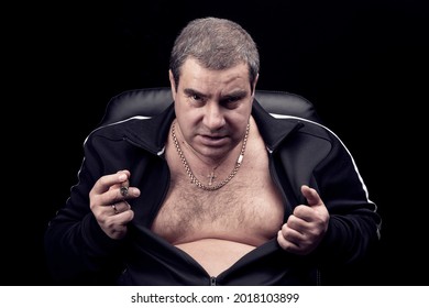 Threatening Look Of The Criminal Of The Russian Mafia, Portrait Of An Adult Dangerous Gangster Man, Smoking A Cigar And Growling Into The Camera