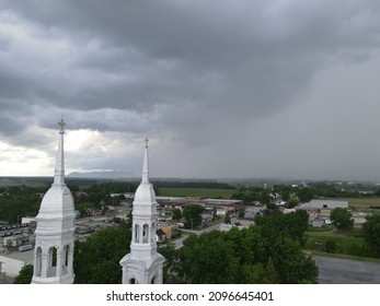 Threatening Sky Over The Steeple Of A Church In The Montérégie Region Of Quebec. The Contrast Of The Heavens.