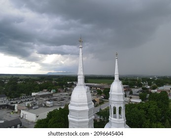 Threatening Sky Over The Steeple Of A Church In The Montérégie Region Of Quebec. The Contrast Of The Heavens.