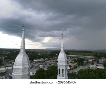 Threatening Sky Over The Steeple Of A Church In The Montérégie Region Of Quebec. The Contrast Of The Heavens.