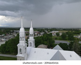 Threatening Sky Over The Steeple Of A Church In The Montérégie Region Of Quebec. The Contrast Of The Heavens.