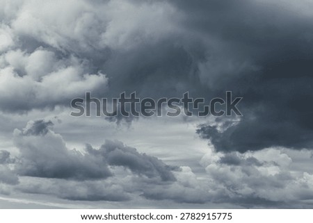 Threatening storm sky. Dramatic dark gray clouds background photo.