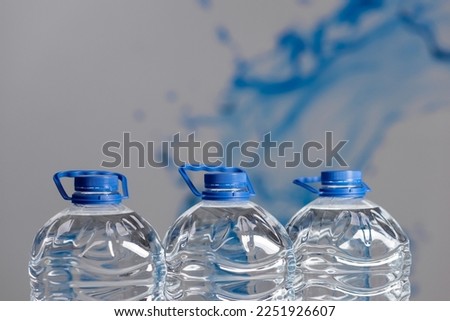 Three 5 liter plastic water bottles close up. Water delivery