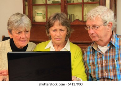 Three Active Senior Citizens Surfing The Internet.