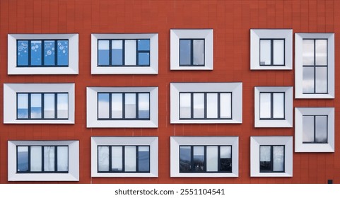 Three adjacent apartment buildings with contrasting modern facades. Patterns of orange, white, brown, blue, green, and pink panels highlight their unique architectural styles. - Powered by Shutterstock