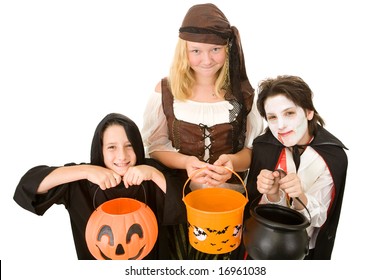 Three Adorable Trick Or Treaters Begging For Halloween Candy.  Isolated On White Background.