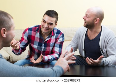 Three Adult Men Talking  At Living Room