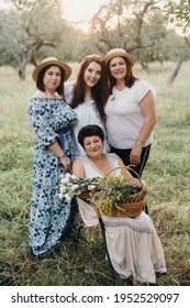 Three Adult Sisters With Mom In Summer Garden
