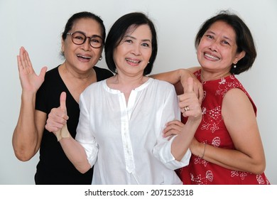 Three Adult Women Smiling And Greeting Together In A Casual Party